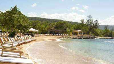 Beachside bar and turquoise water at Bamboo Blu Beach Club in Mammee Bay, Jamaica