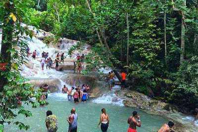 Visitors climbing Dunn's River Falls terraced waterfall in Ocho Rios Jamaica