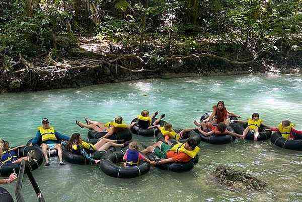 White River Tubing Jamaica - families floating on inner tubes turquoise river jungle