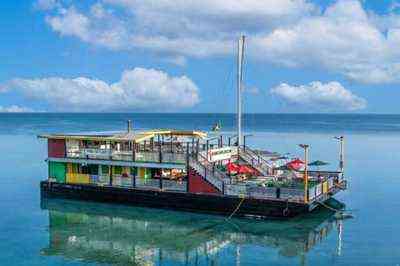 Poko Loko Ocho Rios Jamaica - floating restaurant bar on the Caribbean Sea Jamaican flag