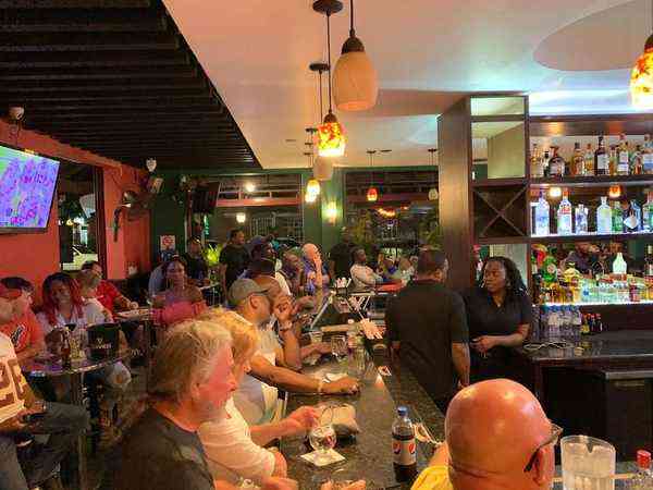 John Crow's Tavern Ocho Rios Jamaica - busy bar night locals watching sports drinks