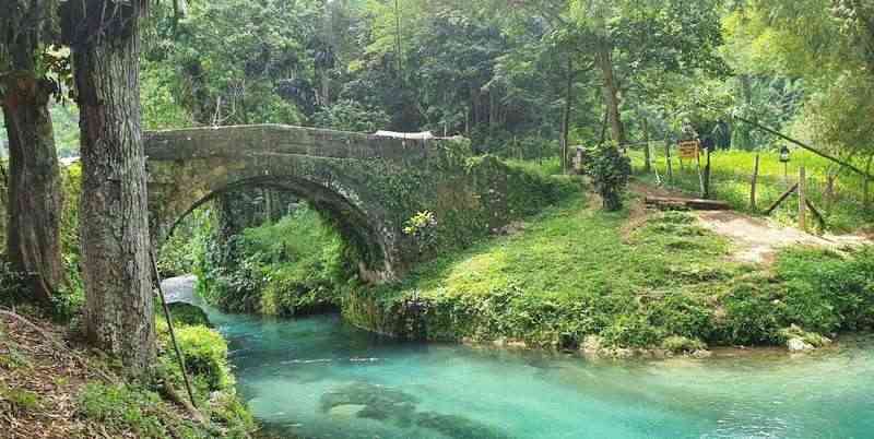 Old Spanish Bridge Jamaica - ancient stone bridge over turquoise river pool deep swimming hole