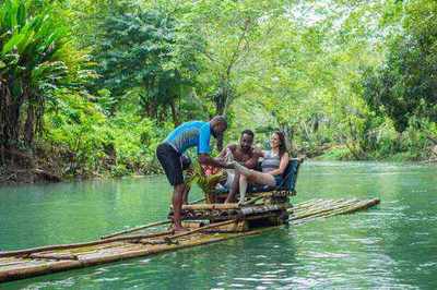 Traditional bamboo raft gliding along the serene White River, Jamaica