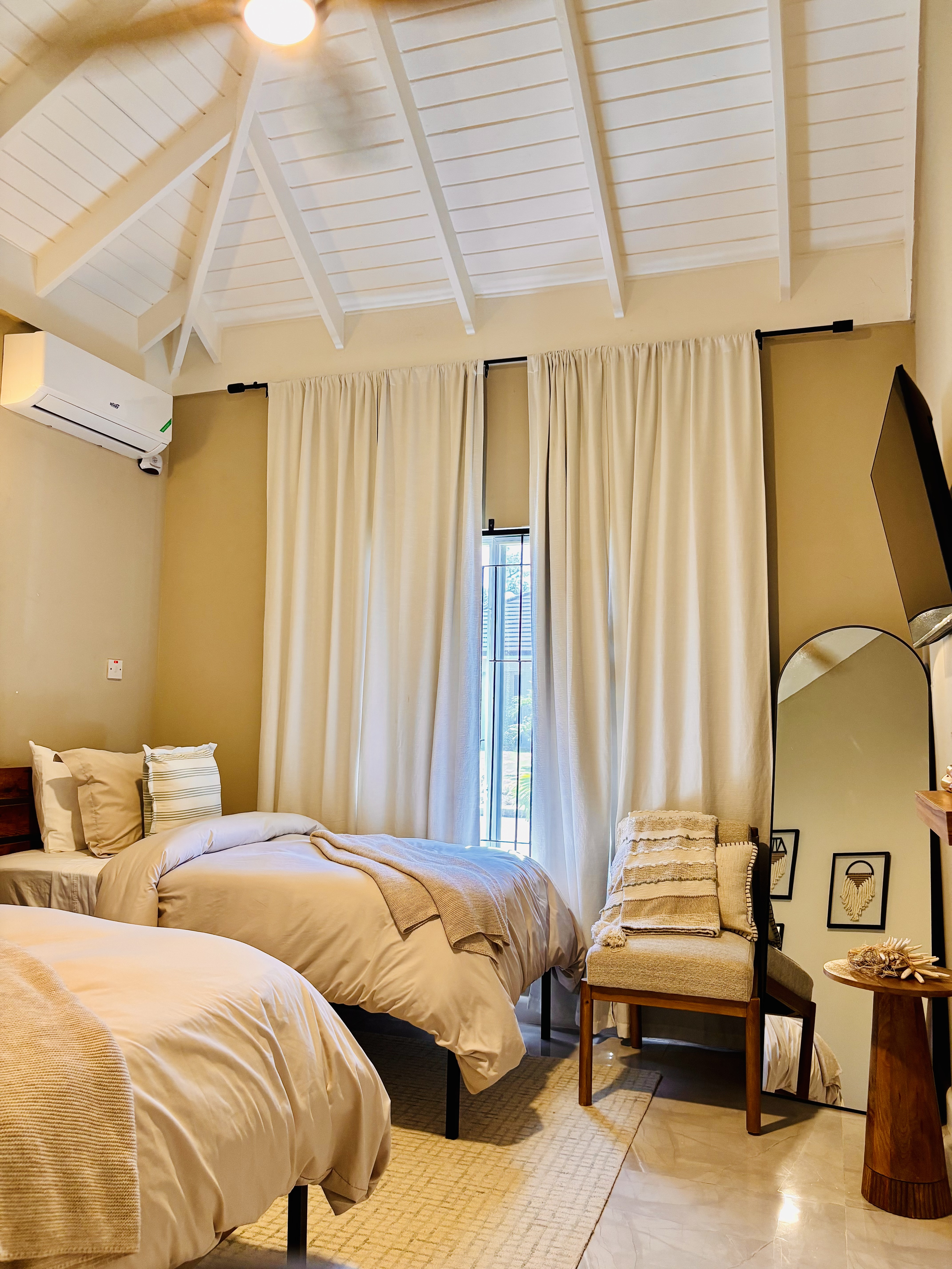 Twin bedroom with soft neutral linens